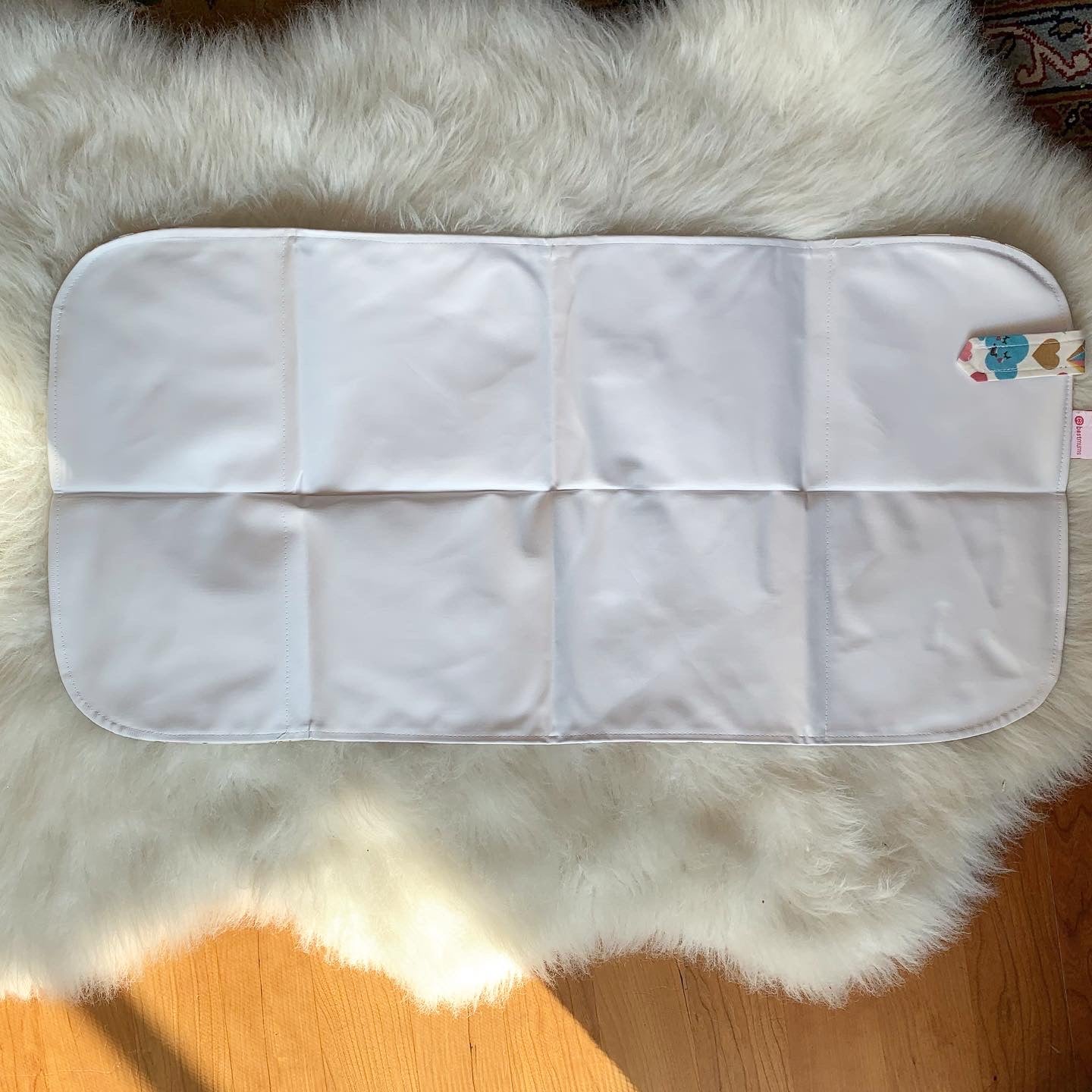 Baby on Unicorn changing mat during diaper change

