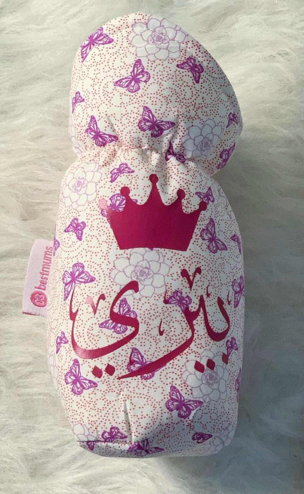 Purple Butterfly cover fitted over a baby bottle
